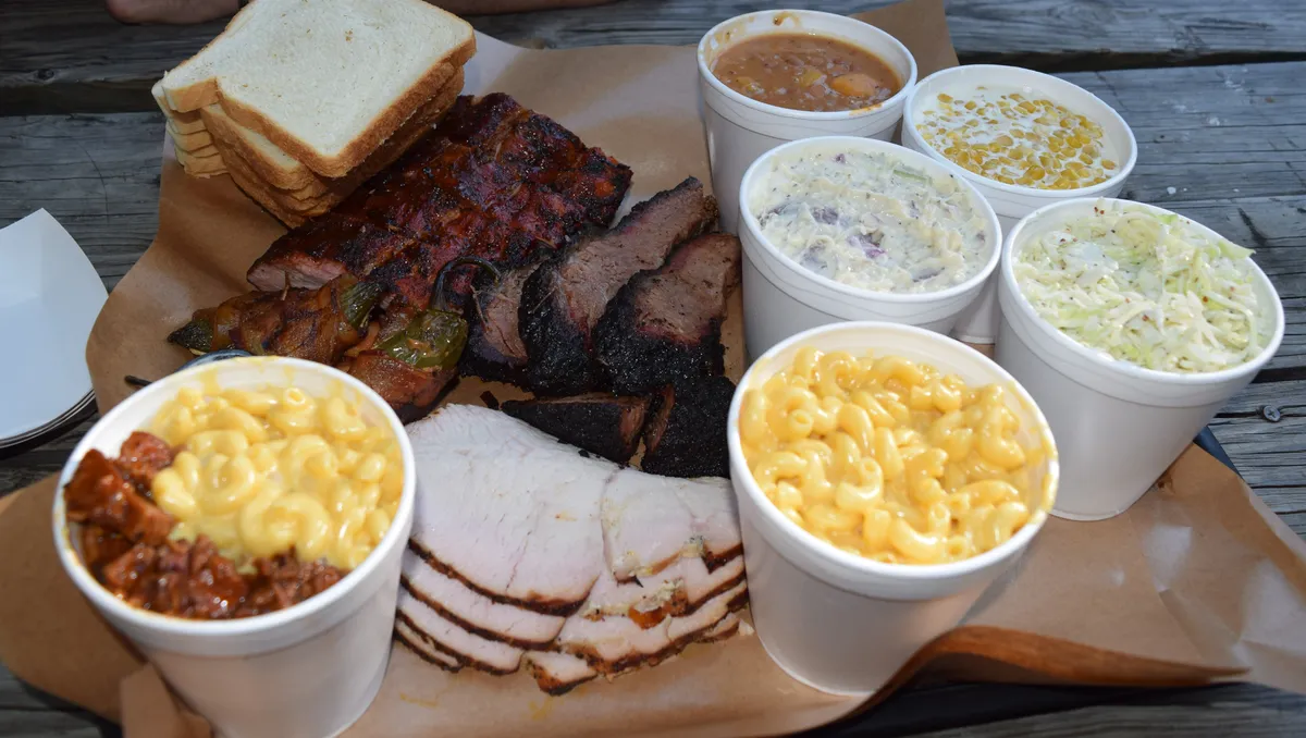 Two Bros. BBQ Market signature dishes Plain Bro Tato, Loaded Bro Tato, Smoked Sliced Brisket.